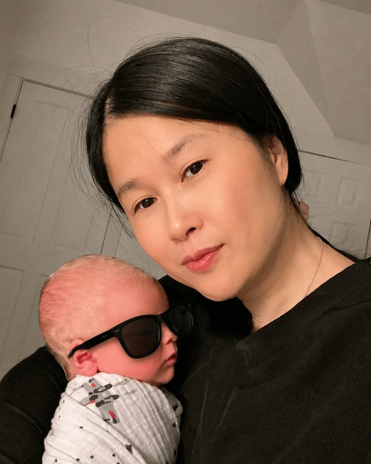 Akim holding a swaddled newborn she cared for